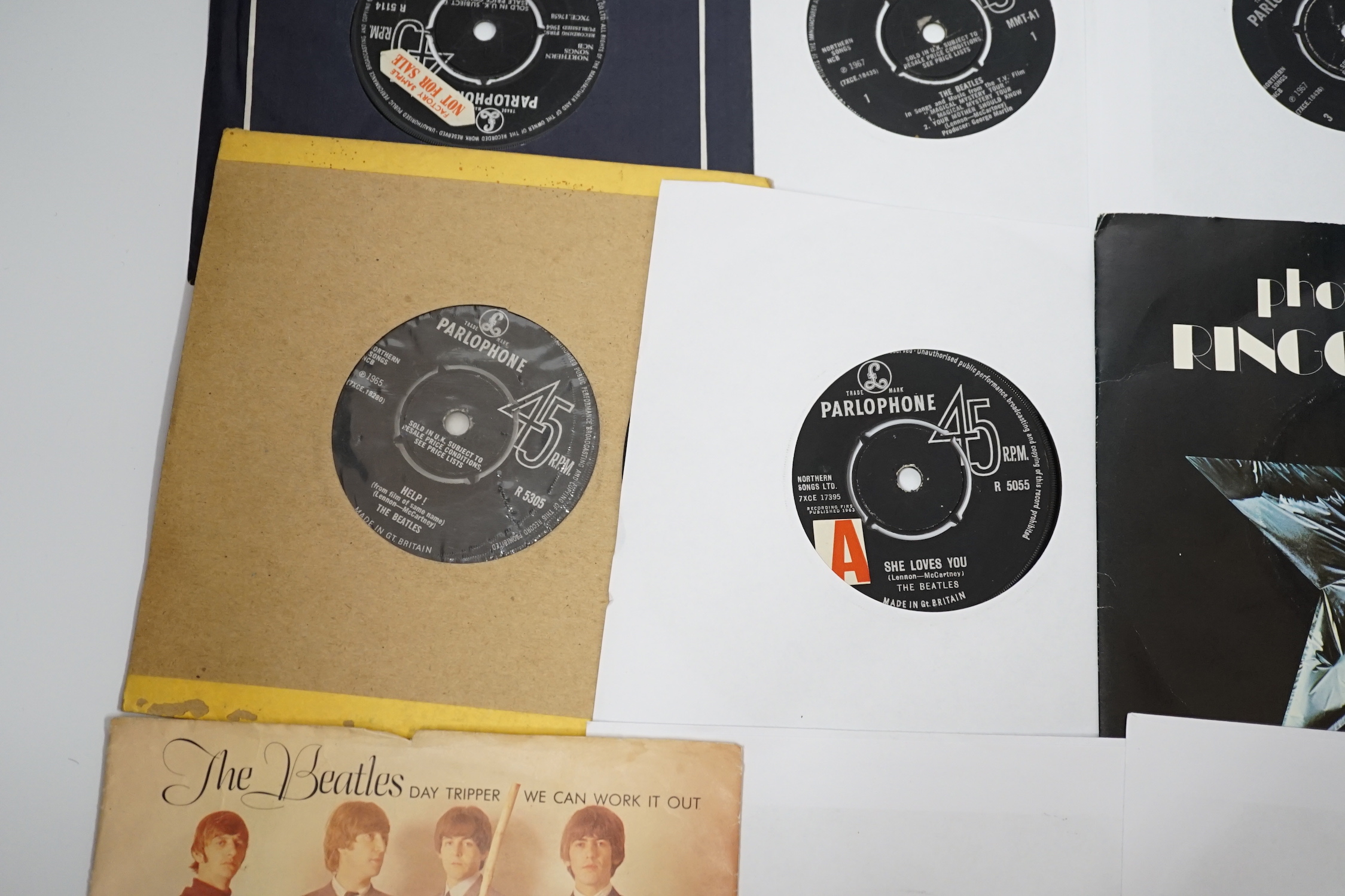 Thirteen The Beatles and related 7 inch singles; eight of which have demo stickers; ‘Factory Sample Not For Sale’